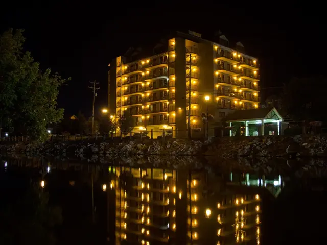 The tower at night, reflected in the Little Pigeon River