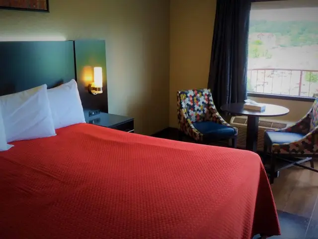 King Jacuzzi Suite with seating area and balcony door