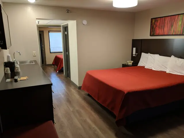 Queen bed and sliding barn door in the Two Bedroom Family Suite