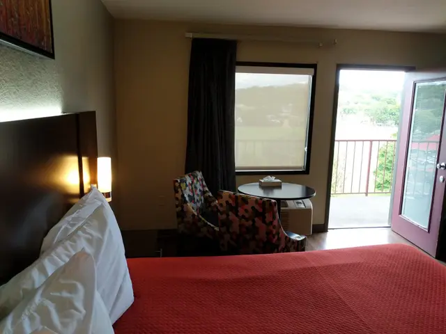 Bedroom with table, chairs and open balcony door