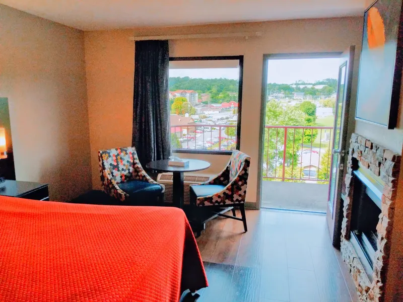 Family suite with fireplace, seating area and open balcony door