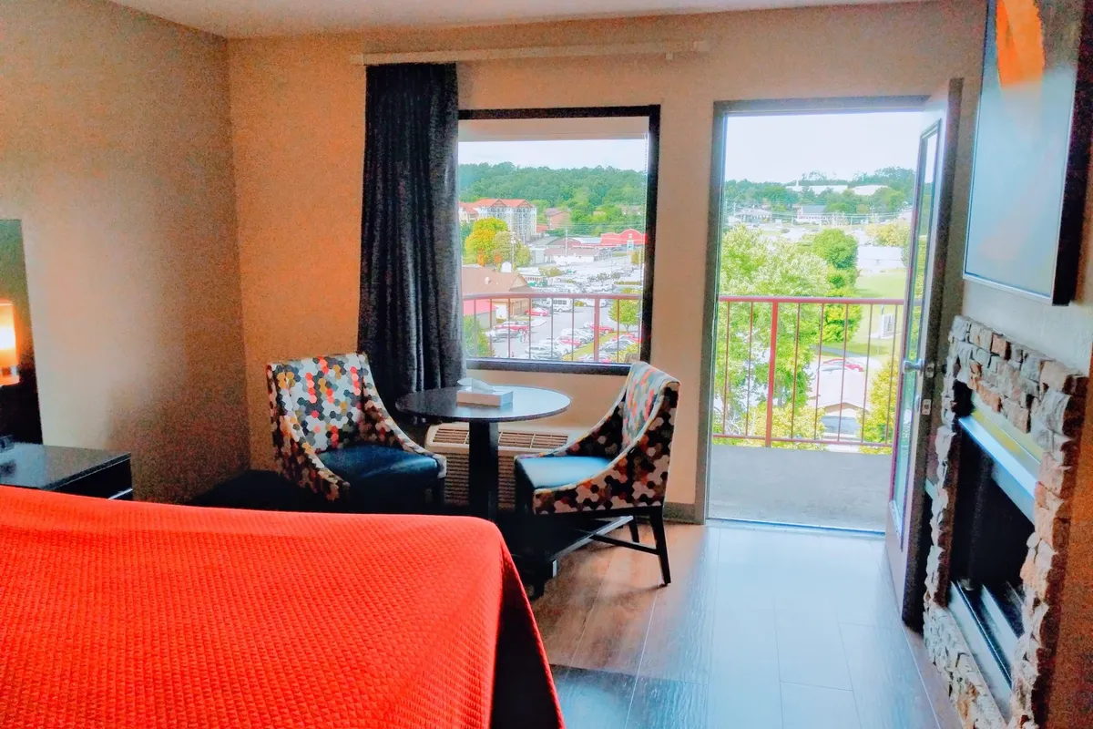 Family suite with fireplace, seating area and open balcony door